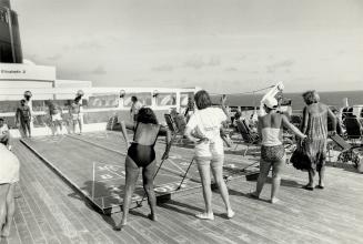 At right, deck games under a fiery Caribbean sun