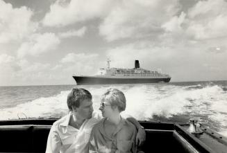 On the cruise of a lifetime, a young couple leave the QE2 riding the swells behind them as they head for a day in martinique