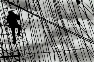 Voyage of discovery, A teenager climbing the rigging of the Polish barkentine Pogoria is silhouetted against the sky in Toronto harbor yesterday. The (...)
