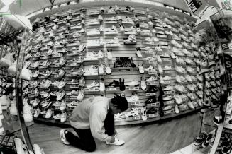 Wall of shoes: Stores such as Athletes World in the Eaton Centre barely have wall space for the varieties and brands of running shoes now available