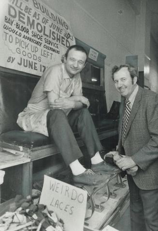 A Final Shine: Alex Tsandilis, owner of Bay & Bloor Shoe Service, gets a shine from cousin Steve Trifunoff, who came to help close down the shop that had been in the same building for 44 years
