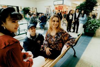 Hangin' out: Youth worker Manny Correia talks with Lorena Sackaney, left and Antia Wilczynska in Dufferin Mall