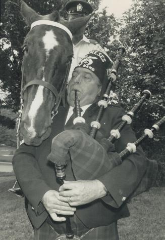 Musically inclined, Police horse Bess leans to get earful of Shriner Allan Caird's pipes