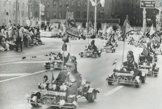 Parading up University Ave. in today's 14,000-strong Shriners parade, members of the Go Cart patrol from the Peel Shrine Club roll along in their mini(...)