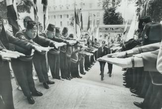 Honor guard of Shriners salutes, with outstretched arms, as potentate enter St