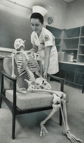 'Are you comfortable, Sir?', Student nurse Nora Varga arranges a skeleton as part of a nursing-assistant department display for an exhibition at Centr(...)