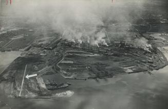 Built of Slag from blast furnaces, the recently constructed landing strip, indicated by arrow, at the strike-bound Hamilton plant of the Steel company(...)