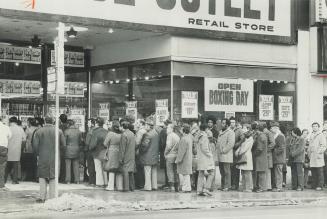 Shoppers line up on Yonge St. yesterday waiting for stores to open with their Boxing Day sales. Much of the business was in exchanges and refunds rath(...)