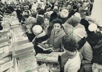 They're doing their Christmas shopping early, Crowds of eager shoppers, looking for bargains in cards for Christmas, 1974, thronged stores today. Some(...)