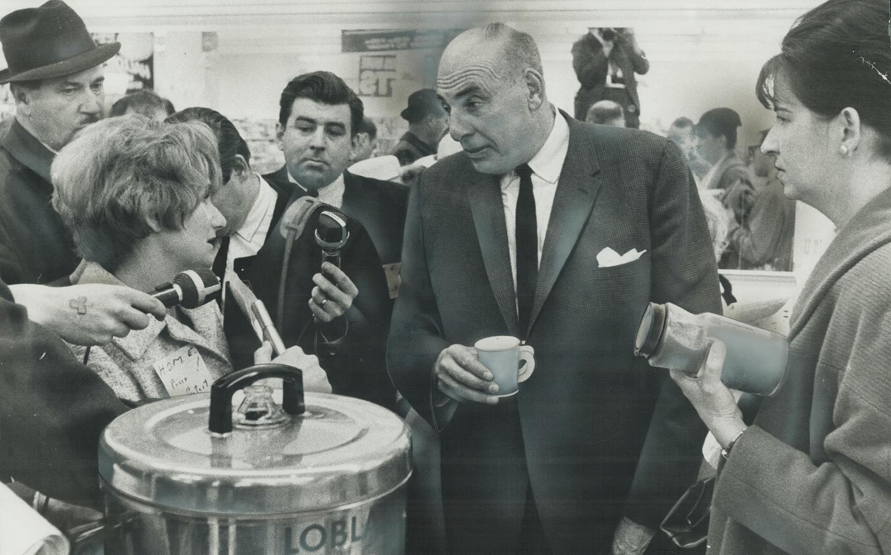 Loblaws vice-president f. w. Morley talks prices with protestor, He remained unruffled, kept smiling and pouring coffee for the housewives