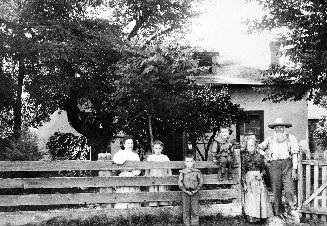 Mr. and Mrs. Joseph Miller and family in front of home