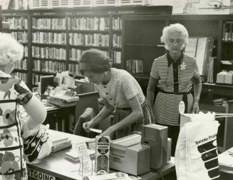 Susan Beynon, branch head, at outgoing desk of the Beaches branch, Toronto Public Library