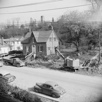 C.W. Jeffreys house, east side of Yonge Street, north of York Mills Road., being prepared for being moved. View looking north east. Toronto, Ontario