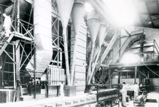 Image shows a number of people working inside the factory.