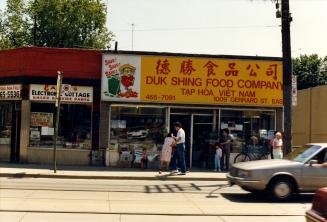 Image shows a grocery store along the street in a one storey building.