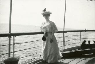 Jean Conan Doyle standing at rail aboard ship
