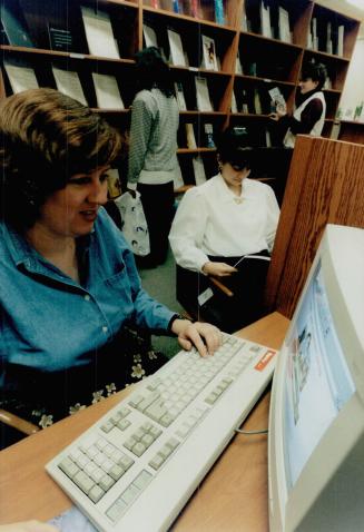 Christine Anderson, left, and Mara Afable work at the Investor Learning Centre, which helps people eager to manage their own investments
