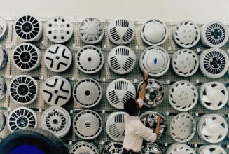 Canadian Tire employee Hasan Hirsi readies the hubcaps for the opening of the company's new big box-style store at St