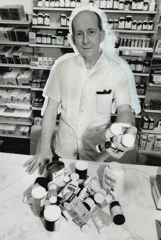 Plenty of pills: John Rumball shows a typical large assortment of pills and medications found in some senior citizens' homes