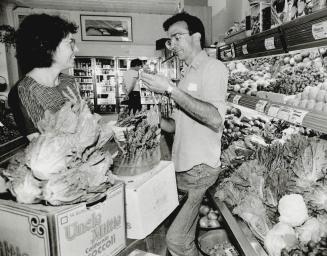 Produce: The Big Carrot's manager Mary Lou Morgan and David Dennis arrange vegetables and fruit in the Riverdale-area store, which is owned and operated as a worker co-operative