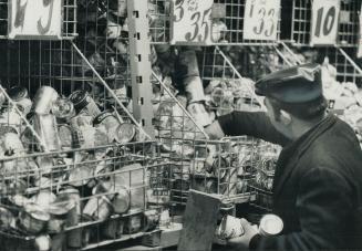 A shopper reaches for a bargain at Usher's Surplus Food Warehouse on Queen St