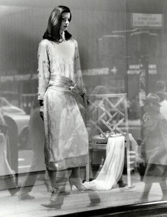 Sheer elegance: Geoffrey Beene's white dress is offset by chair and throw at Saks Fifth Ave