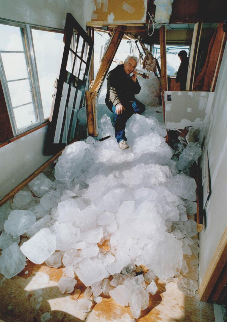 House damaged: Keswick resident Fred Hornsby surveys damage caused by a huge mass of ice that slammed into his house from Lake Simcoe Friday