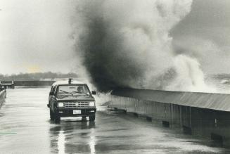 Ed Ciantar, supervisor of security at Ontario Place, drives a truck along the road by the breakwall as 3-metre (10-foot) Lake Ontario waves pelt down (...)