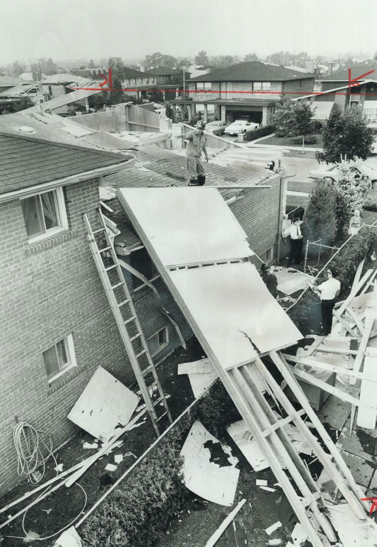 Among the damaged houses in yesterday's storm were these two on North York's Rockland Dr. No injuries were reported but homes and roads were flooded, (...)