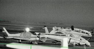Storm's wake: Two flipped planes rest piggyback on the tarmac at Toronto Island Airport
