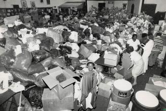 Jamaican relief flows in. Volunteer Iris John, centre, helps sort the abundance of clothing donated to the Jamaican Relief Collection centre on Dupont(...)