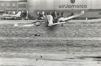 Path of destruction: A light plane (top) is bowled over at Jamaica's Kingston Airport, sailboats are swamped and grounded at Montego Bay, and vacation cabins at Runaway Bay are ripped apart