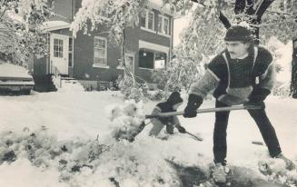 Shovelling out: With a little help from son Brian, 3, Malcolm Watts of Alliston clears his driveway today after an overnight 30-centimetre snowfall