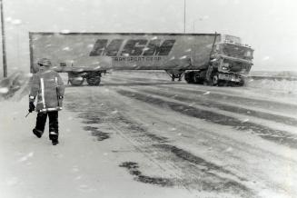 Storm Victim: Slippery roads yesterday forced this tractor-trailer to jack-knife on the ramp leading from Highway 403 to the eastbound lanes of Highway 401