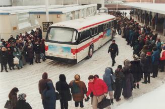 Historic photo from Wednesday, January 13, 1999 - Yonge and Eglinton subway station - people lining up in the bus bays for replacement TTC buses after subway breakdown in Yonge and Eglinton