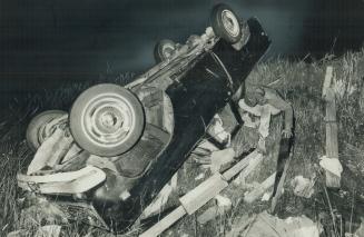 Jacob Steef, 16, examines what's left of a truck that was tossed 100 yards by a tornado that struck Oxford Centre
