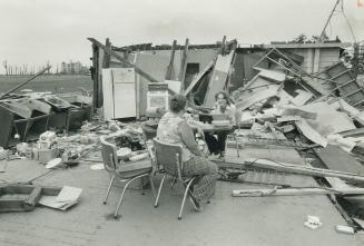Oxford Centre residents Wanda Lively (left) and Darlene Wilson take a break from rummaging in the rubble for their possessions
