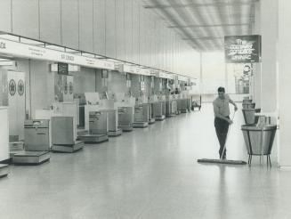 Cleaning man is a lonely figures in air Canada's Departure area at Malton, because of strike