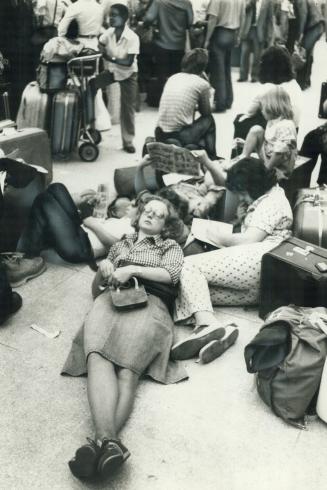 Disgrunted travellers hung up at Toronto International Airport by the Air Canad shutdown try to make the best of things