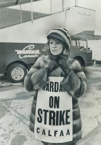 Clutching her collar against the January wind, stewardess Janie Grimwood walks the picket line at Malton Airport