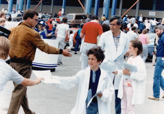 Information campaign: Striking doctors stood outside Exhibition Stadium yesterday to hand out literature on their reasons for their fight against extra-billing