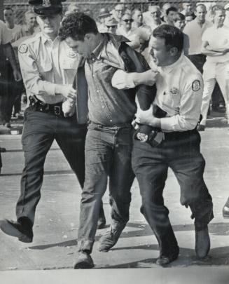 Hamilton police drag away one of the fighting pickets