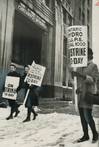 Hydro strikers carrying placards walk picket line today in front of Hydro offices on University Ave