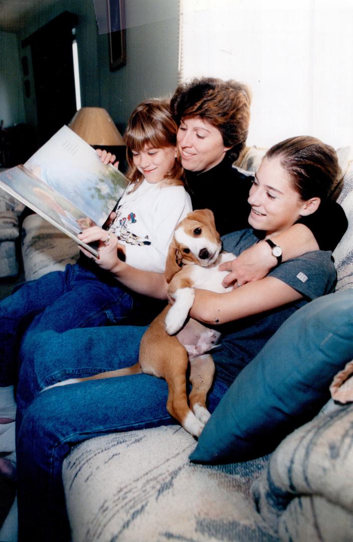 Home work: School bus driver Judy Poirier, laid off because of the teachers' strike, reads with daughters Michelle, 8, (left) and Tracey, 12