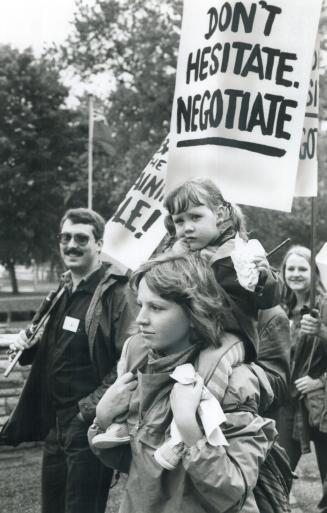Uneasy rider, This little girl looked a bit dubious about things as she was carried at a Queen's Park demonstration by students whose community colleges have been closed by teachers' strike