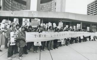 Strikers demonstrate: About 100 of the 400 central library workers who have been on strike for six weeks demonstrate in Nathan Phillips Square yesterday before a Metro council meeting