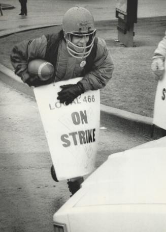 Exercise break on picket line, Employee Andrew Lane tosses a football around on the picket line at Lily Cups' Markham Rd. plant yesterday. The union w(...)