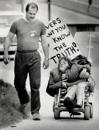 Joanne Stoodley rode her wheelchair on a 4 1/2-hour trek yesterday to show her support for striking Wheel-Trans drivers