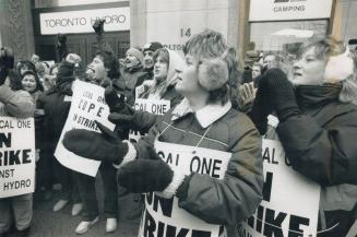 Hundreds of striking Toronto Hydro workers rally in front of the utility's head office on Carlton St