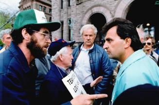 Demonstrators argue at Queen's Park after strikers at the Oshawa Food Group prevented farmers from delivering produce to the adjacent Ontario Food Terminal